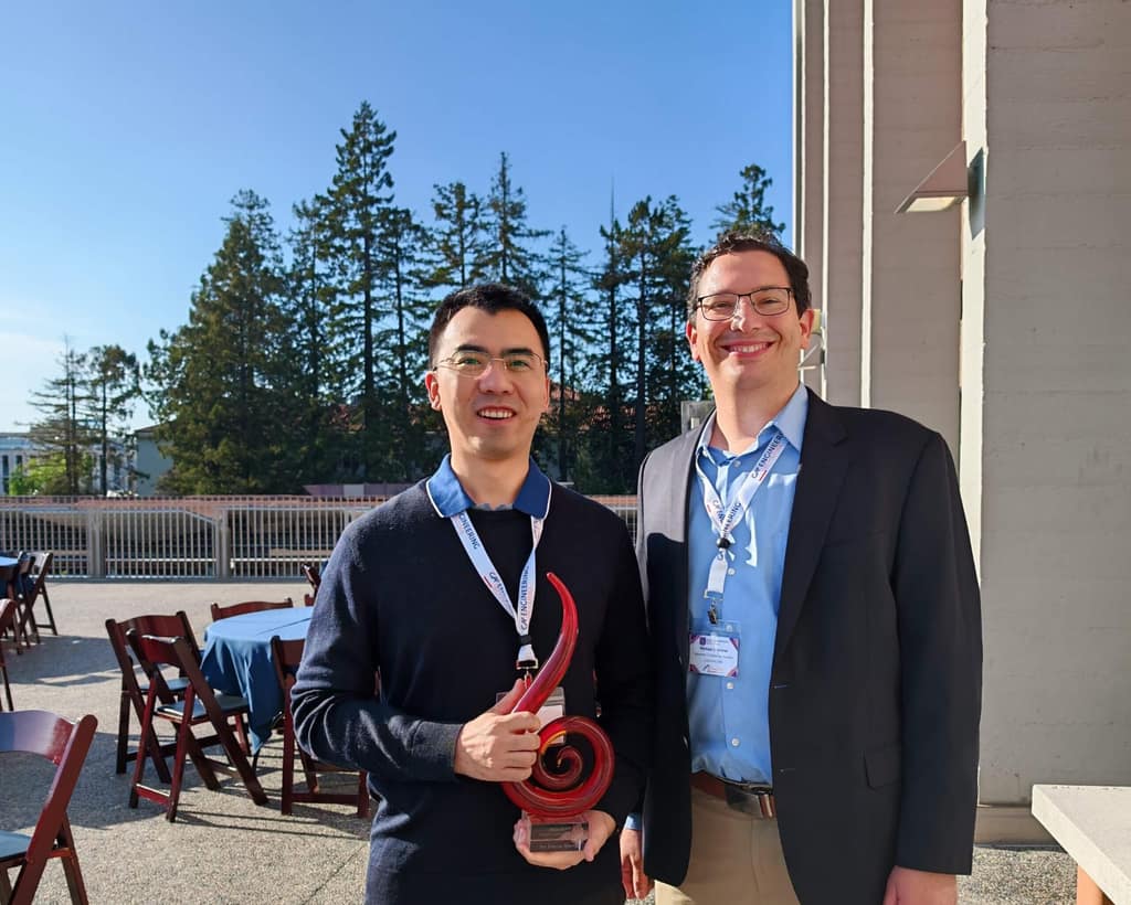 Xinyan Huang receiving an IAWF award
